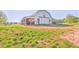 Large, white barn with sliding doors and a sheltered area on a vast, grassy property at 1288 Reavesville Rd, Bowdon, GA 30108