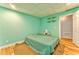 Spacious basement area features cozy bed with a green quilt at 1288 Reavesville Rd, Bowdon, GA 30108
