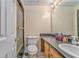 Neutral bathroom featuring a shower, toilet, vanity, and a well-lit mirror at 1288 Reavesville Rd, Bowdon, GA 30108