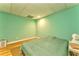 Cozy bedroom with light green walls, hardwood floors and a comfortable bed with a green quilt at 1288 Reavesville Rd, Bowdon, GA 30108