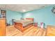 Comfortable bedroom features wood floors, accent wall, and ample storage; perfect for relaxing at 1288 Reavesville Rd, Bowdon, GA 30108