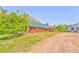 Beautiful log cabin with a porch and green metal roof, set on a sprawling property at 1288 Reavesville Rd, Bowdon, GA 30108