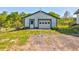 Rustic, one-car garage with a green trim door and a white garage door on a beautiful lot at 1288 Reavesville Rd, Bowdon, GA 30108