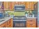 A close up on the oven and microwave featuring a variety of small kitchen appliances at 1288 Reavesville Rd, Bowdon, GA 30108