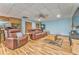 Basement living room featuring hard wood floors, leather furniture, and a ceiling fan at 1288 Reavesville Rd, Bowdon, GA 30108