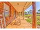 Inviting covered porch with wooden rocking chairs overlooking the home's front yard at 1288 Reavesville Rd, Bowdon, GA 30108