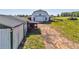 Scenic view of a white barn and green-trimmed storage building on a vast, grassy property at 1288 Reavesville Rd, Bowdon, GA 30108