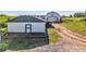 Scenic view of green-trimmed storage building with a white barn in the background at 1288 Reavesville Rd, Bowdon, GA 30108