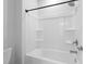 Clean bathroom featuring tub shower combo with soap shelves and black hardware at 1815 Wellston Dr, Lawrenceville, GA 30043