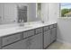 Bathroom with gray vanity, double sinks, undermount storage, and bright window at 1815 Wellston Dr, Lawrenceville, GA 30043