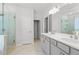 A spacious bathroom featuring a double sink vanity, walk-in shower, and tile floors at 1815 Wellston Dr, Lawrenceville, GA 30043