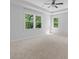 A bedroom with carpet, two windows, and a ceiling fan at 1815 Wellston Dr, Lawrenceville, GA 30043
