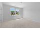 Bright bedroom featuring plush carpet, neutral paint, and a double window overlooking the neighborhood at 1815 Wellston Dr, Lawrenceville, GA 30043