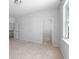 Spacious bedroom with neutral carpet, closet, door to ensuite, and a window allowing natural light at 1815 Wellston Dr, Lawrenceville, GA 30043