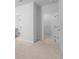 Hallway leading to a bathroom and walk-in closet with plush carpet flooring at 1815 Wellston Dr, Lawrenceville, GA 30043