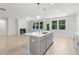 Bright, open-concept kitchen with island, stainless steel appliances and views of the living room and backyard at 1815 Wellston Dr, Lawrenceville, GA 30043