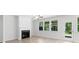 Bright living room with fireplace, large windows, light colored floors and access to the backyard patio at 1815 Wellston Dr, Lawrenceville, GA 30043