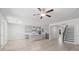 Spacious open-concept living area with kitchen, dining, staircase, fireplace, and light colored floors at 1815 Wellston Dr, Lawrenceville, GA 30043