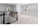 View from upper level landing featuring an open floor plan with black metal railings and carpeted floors at 1815 Wellston Dr, Lawrenceville, GA 30043