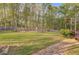 Expansive backyard featuring a playground and bordered by a wooden fence at 209 Red Fern Ct, Canton, GA 30114