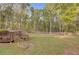 Expansive backyard with mature trees and a wooden deck providing privacy and outdoor enjoyment at 209 Red Fern Ct, Canton, GA 30114