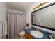 Well-lit bathroom featuring a framed mirror, bath fixtures, and a shower with a neutral-toned curtain at 209 Red Fern Ct, Canton, GA 30114