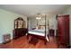 Bedroom with hardwood floors, dresser, and four-poster bed at 209 Red Fern Ct, Canton, GA 30114