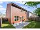 Backyard with artificial turf, patio, brown wood siding, privacy fence, and well-maintained lawn at 261 Highland Village Ln, Woodstock, GA 30188