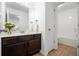 Bathroom featuring a mirror, vanity with granite countertop, and white tub shower combo at 261 Highland Village Ln, Woodstock, GA 30188