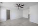 Bright bedroom with gray carpet, ceiling fan, and doorway leading to an adjacent room with wire shelving at 261 Highland Village Ln, Woodstock, GA 30188