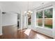 Bright dining area leading to patio, features large windows, and views into the living room and kitchen at 261 Highland Village Ln, Woodstock, GA 30188