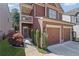 Inviting exterior with a two-car garage, balcony, and beautiful landscaping at 261 Highland Village Ln, Woodstock, GA 30188