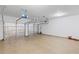 Garage with smooth concrete floor, garage door openers, and two paneled garage doors at 261 Highland Village Ln, Woodstock, GA 30188