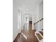 Bright hallway features hardwood floors, staircase, and views of living spaces at 261 Highland Village Ln, Woodstock, GA 30188