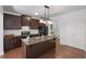 Modern kitchen with dark cabinets, granite countertops, stainless steel appliances, and a center island at 261 Highland Village Ln, Woodstock, GA 30188