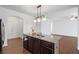 Kitchen island with stainless steel sink and granite countertop; opens to dining and living areas at 261 Highland Village Ln, Woodstock, GA 30188