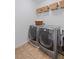 Cozy laundry room with modern washer and dryer, and overhead basket storage at 261 Highland Village Ln, Woodstock, GA 30188