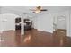 Open-concept living area with hardwood floors, dining area, and arched entryway at 261 Highland Village Ln, Woodstock, GA 30188