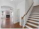 Staircase view of the open living room with fireplace and large windows at 261 Highland Village Ln, Woodstock, GA 30188
