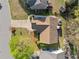 Aerial view of a landscaped property featuring a driveway, lush lawn, and mature trees at 5265 Bentley Hall Dr, Alpharetta, GA 30005