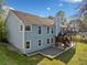 Light blue siding home with a small deck and gray gravel section in the backyard at 5265 Bentley Hall Dr, Alpharetta, GA 30005