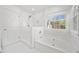 Bright bathroom featuring a soaking tub, step-in shower, and marble tile at 5265 Bentley Hall Dr, Alpharetta, GA 30005