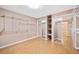 Finished basement bedroom closet offering shelving and laminate flooring at 5265 Bentley Hall Dr, Alpharetta, GA 30005