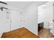 Bright foyer with hardwood floors, a convenient coat rack, and a view into a half bathroom, offering a functional space at 5265 Bentley Hall Dr, Alpharetta, GA 30005