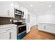 Bright kitchen boasts white cabinets, stainless steel appliances, and a stylish backsplash at 5265 Bentley Hall Dr, Alpharetta, GA 30005