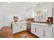 Well-lit kitchen featuring white cabinetry, stainless steel appliances, and a decorative rug at 5265 Bentley Hall Dr, Alpharetta, GA 30005