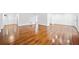 Bright, open-concept living room with gleaming hardwood floors and neutral walls, offering a spacious and inviting atmosphere at 5265 Bentley Hall Dr, Alpharetta, GA 30005