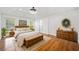Comfortable main bedroom featuring hardwood floors, a ceiling fan, and natural lighting at 5265 Bentley Hall Dr, Alpharetta, GA 30005