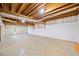Spacious unfinished basement with exposed beams, concrete floors and good natural light at 5265 Bentley Hall Dr, Alpharetta, GA 30005