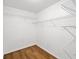 Walk-in closet equipped with wire shelving and hardwood floors at 5265 Bentley Hall Dr, Alpharetta, GA 30005